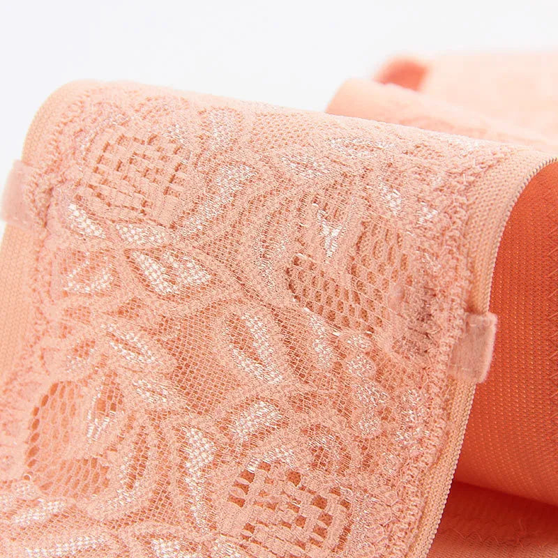 Close-up of breathable lace detail on pink pregnancy support belt
